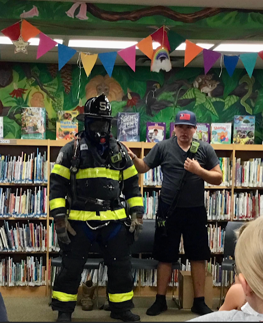 Firefighter Ott describes the turnout gear donned by firefighter Evans-Wright